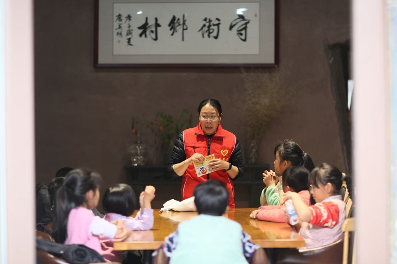 神农架木鱼镇枝子的花园民宿里，文明实践志愿者给小朋友们传授非遗文化.jpg